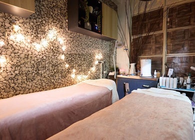 Tranquil treatment room at That Organic Salon, Sydney, New South Wales, AU, with soft lighting and cozy beds.