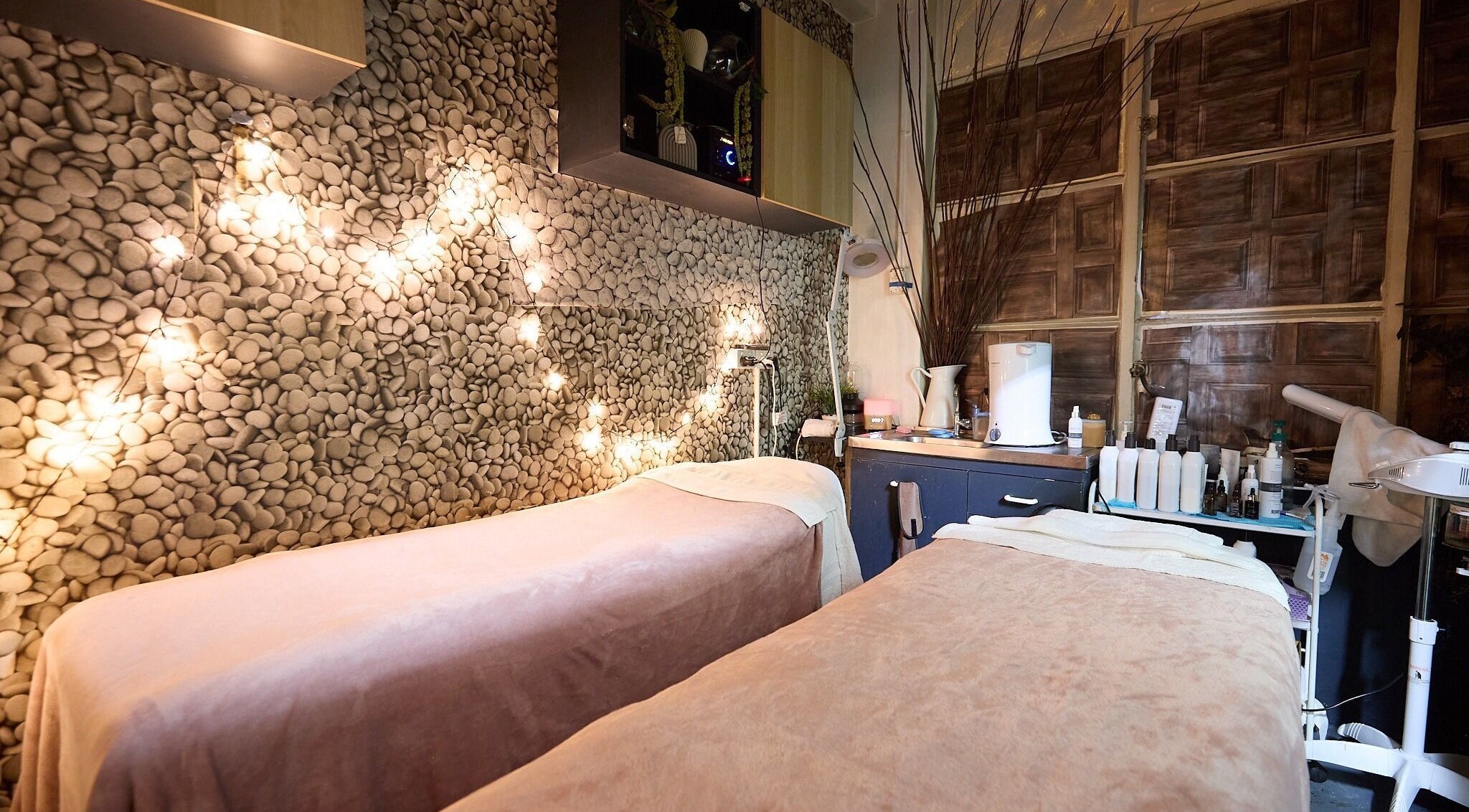 Tranquil treatment room at That Organic Salon, Sydney, New South Wales, AU, with soft lighting and cozy beds.