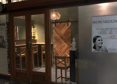 Front entrance of That Organic Salon in Sydney, New South Wales, AU with wooden decor and stylish seating.