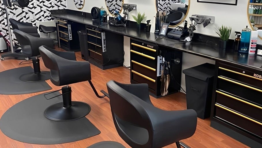 Modern salon chairs at Wax & Hair Boudoir, Irmo, South Carolina, US, showcasing sleek black design.