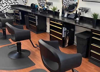 Modern salon chairs at Wax & Hair Boudoir, Irmo, South Carolina, US, showcasing sleek black design.