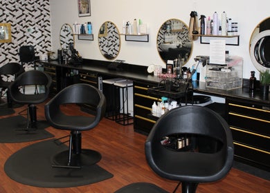 Modern salon at Wax & Hair Boudoir, Irmo, South Carolina, US, featuring stylish chairs and mirrors.
