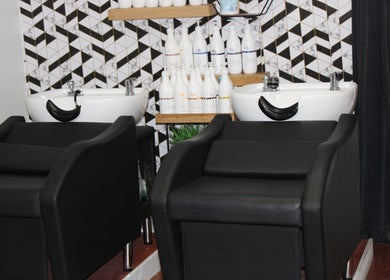 Modern wash station at Wax & Hair Boudoir in Irmo, South Carolina, US. Chic salon decor and hair care products.