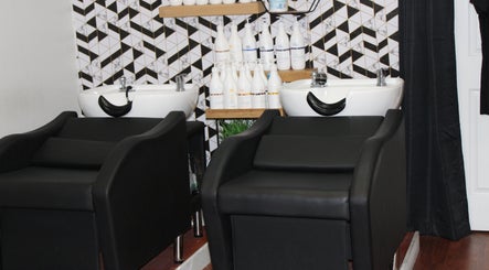 Modern wash station at Wax & Hair Boudoir in Irmo, South Carolina, US. Chic salon decor and hair care products.