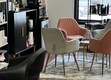 Cozy seating area at Wax & Hair Boudoir, Irmo, South Carolina, US, featuring stylish chairs and beauty products.