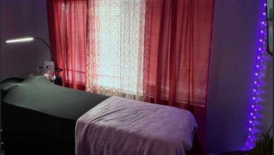 Cozy treatment room at Luxelashes.Dy, Las Vegas, Nevada, US, with soft lighting and red curtains.