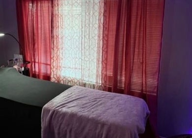 Cozy treatment room at Luxelashes.Dy, Las Vegas, Nevada, US, with soft lighting and red curtains.