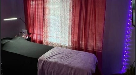 Cozy treatment room at Luxelashes.Dy, Las Vegas, Nevada, US, with soft lighting and red curtains.