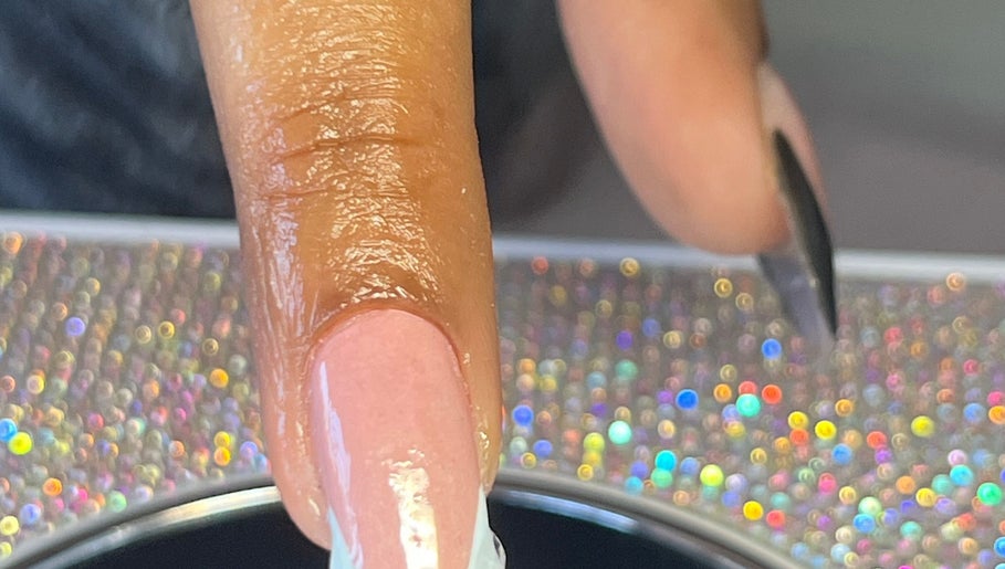 Close-up of a manicured nail at NailswithAmy, Western Cape, Western Cape, ZA with a glittering background.