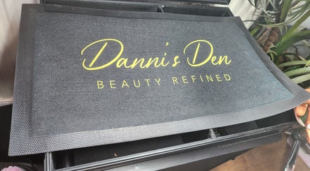 Logo mat at Danni's Den: Beauty Refined in Wellingborough, England, GB.