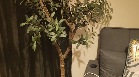 Elegant room plant and cozy chair at Danni's Den: Beauty Refined, Wellingborough, England, GB.