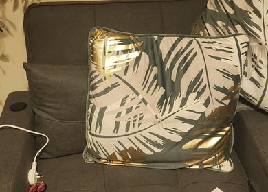 Luxury cushion on grey chair at Danni's Den: Beauty Refined, Wellingborough, England, GB.