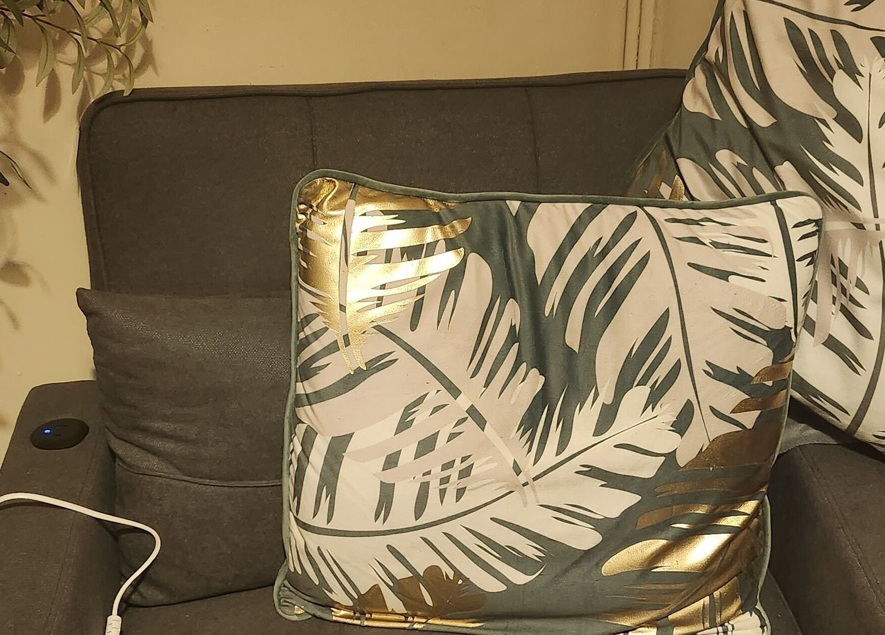 Cozy seating with tropical leaf cushions at Danni's Den: Beauty Refined, Wellingborough, England, GB.