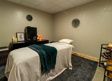 Cozy massage room at Sol Rise Massage, North Salt Lake, Utah, US, featuring a massage table and calming decor.