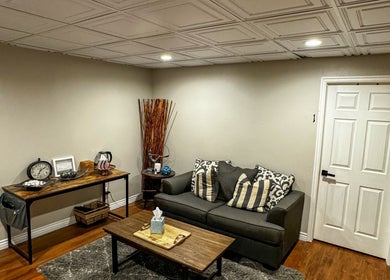 Inviting lounge area at Sol Rise Massage in North Salt Lake, Utah, US, featuring a comfy sofa and elegant decor.