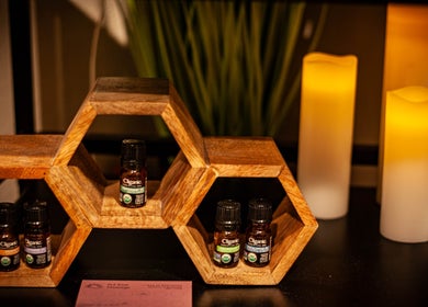 Aromatherapy oils at Sol Rise Massage, North Salt Lake, Utah, US with warm candlelight and wooden decor.