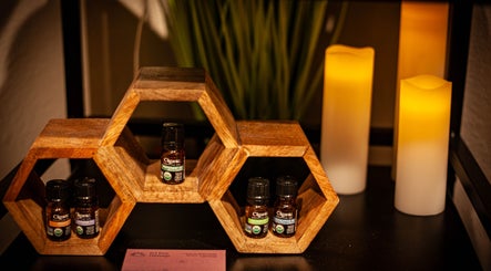 Aromatherapy oils at Sol Rise Massage, North Salt Lake, Utah, US with warm candlelight and wooden decor.