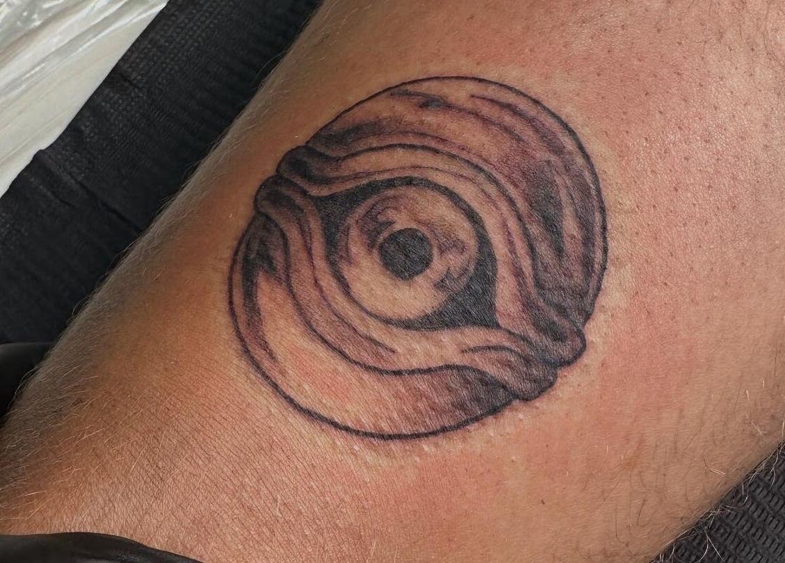 Unique circular tattoo at Taisia's Ink Lab in Watford, England, GB showcasing intricate detailed art.