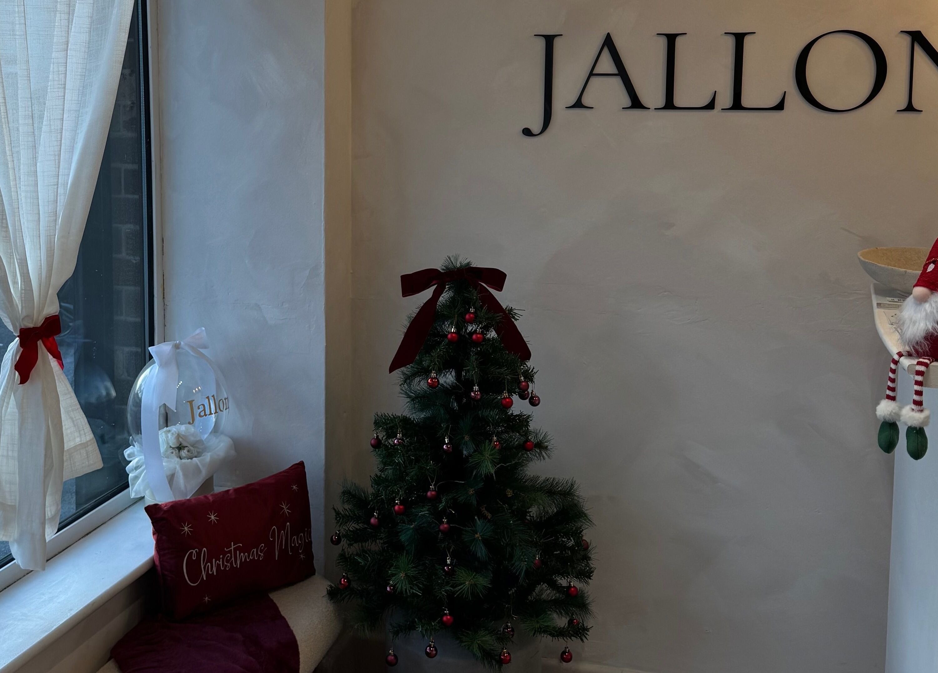Festive holiday decor at Monetlillyhair, Clifton, England, GB with a small Christmas tree and red accents.