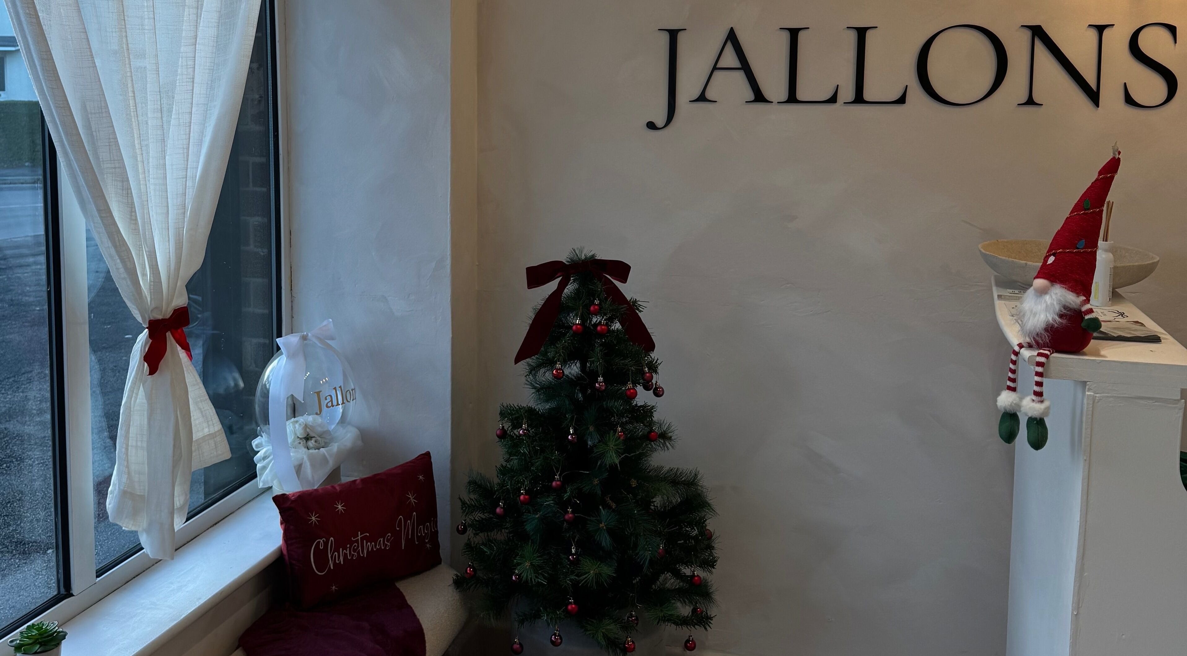 Festive holiday decor at Monetlillyhair, Clifton, England, GB with a small Christmas tree and red accents.