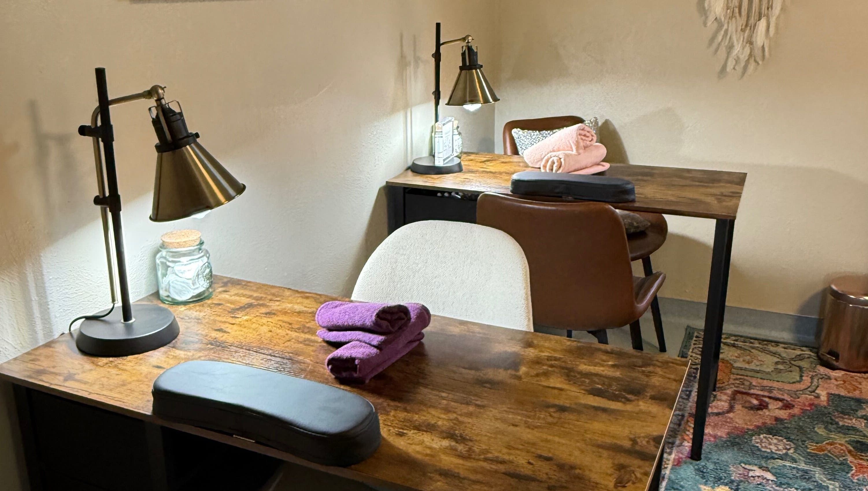 Inviting nail salon setup at Nails By Nikki in Nederland, Colorado, US with plush chairs and wooden tables.