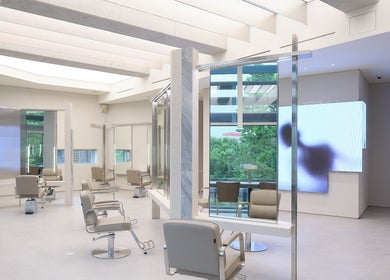 Bright, modern salon interior at HE:ARTS Dosan, Seoul, 서울특별시, KR showcasing sleek design and styling stations.
