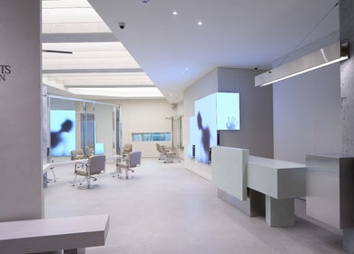 Sleek interior of HE:ARTS Dosan in Seoul, 서울특별시, KR with modern chairs and illuminated walls.