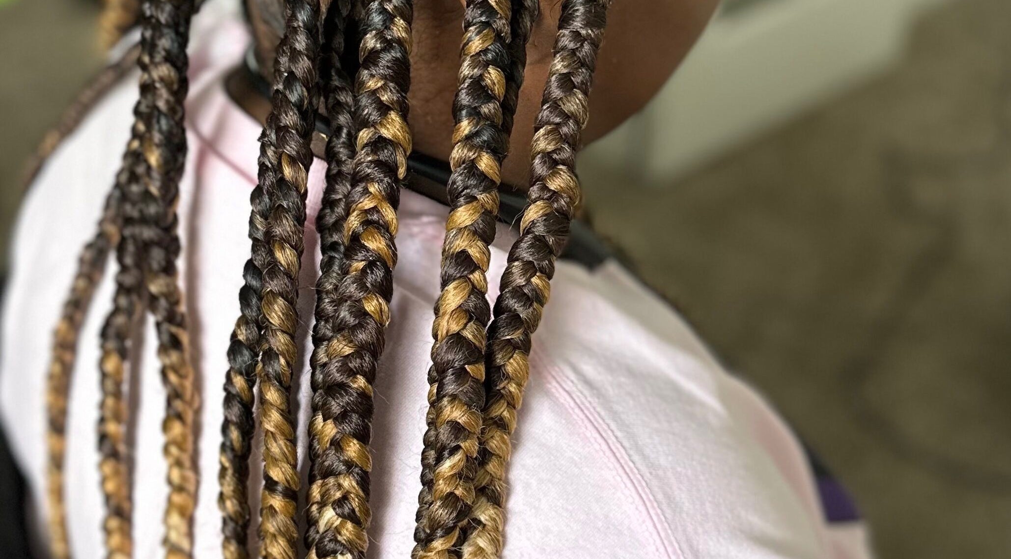 Close-up of intricate braids at Natural Braids By Val in Indianapolis, Indiana, US, showcasing vibrant styles.