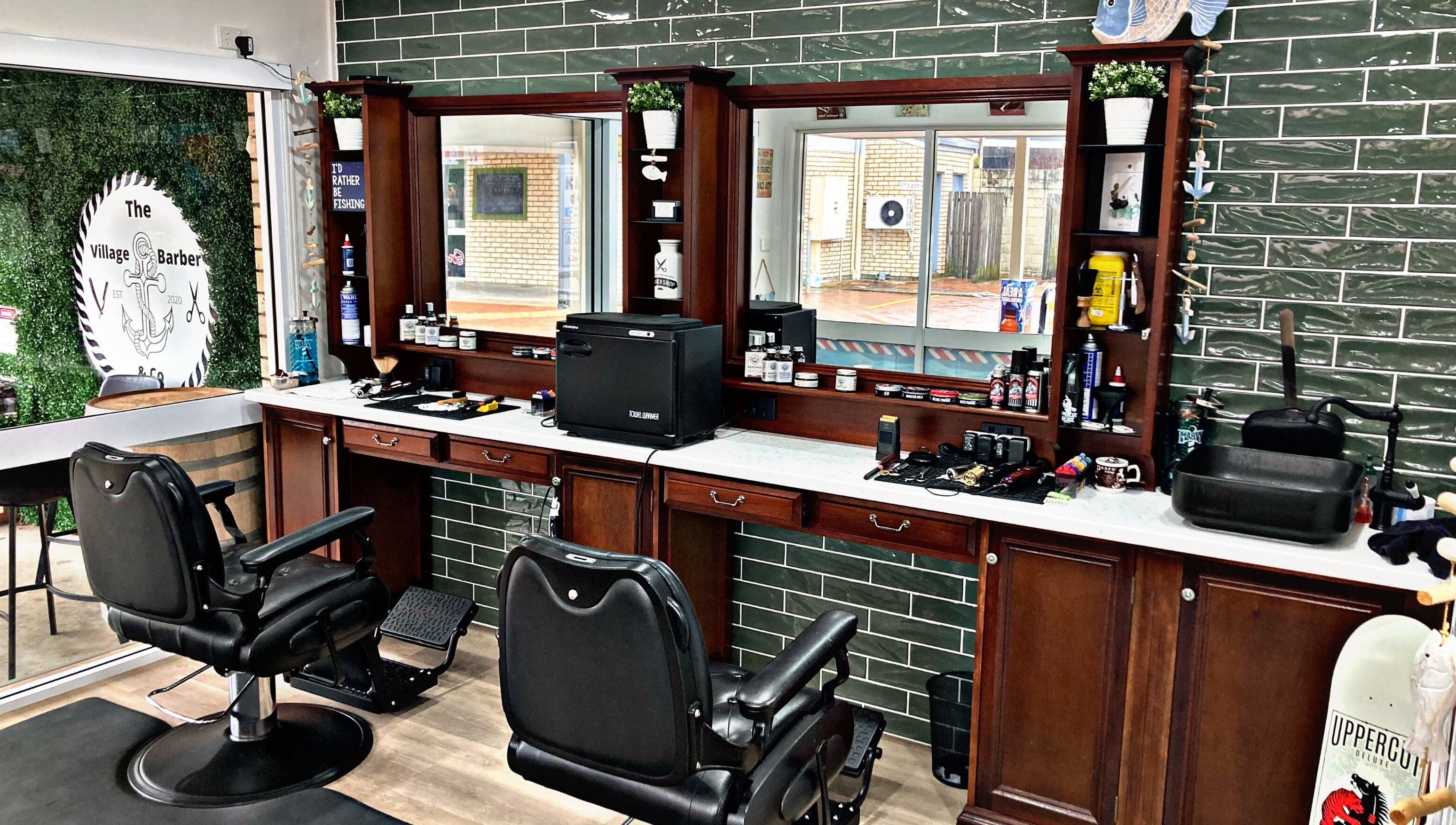Interior of The Village Barber & Co, Scarness, Queensland, AU, showcasing elegant chairs and grooming products.
