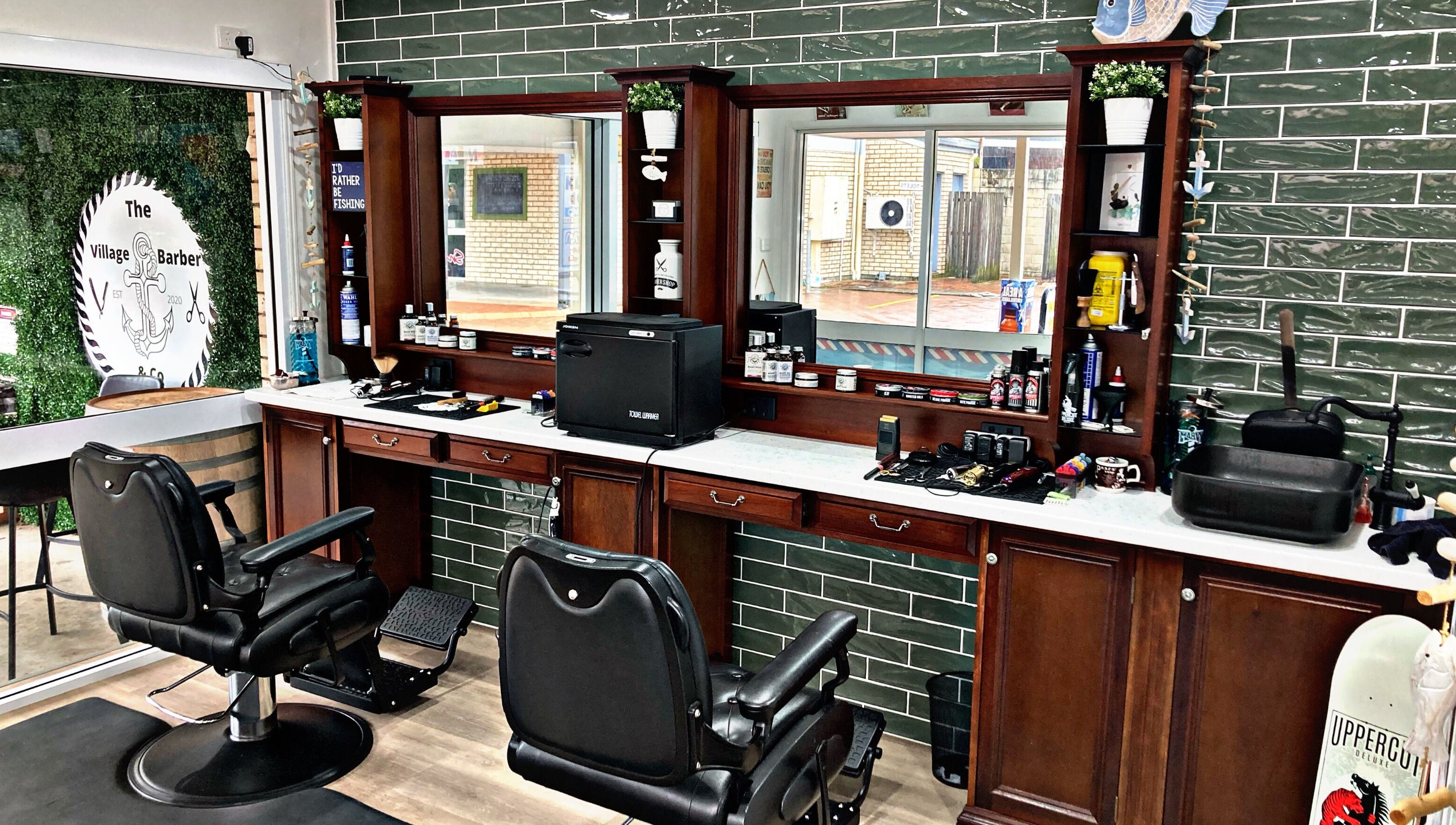 Interior of The Village Barber & Co, Scarness, Queensland, AU, showcasing elegant chairs and grooming products.