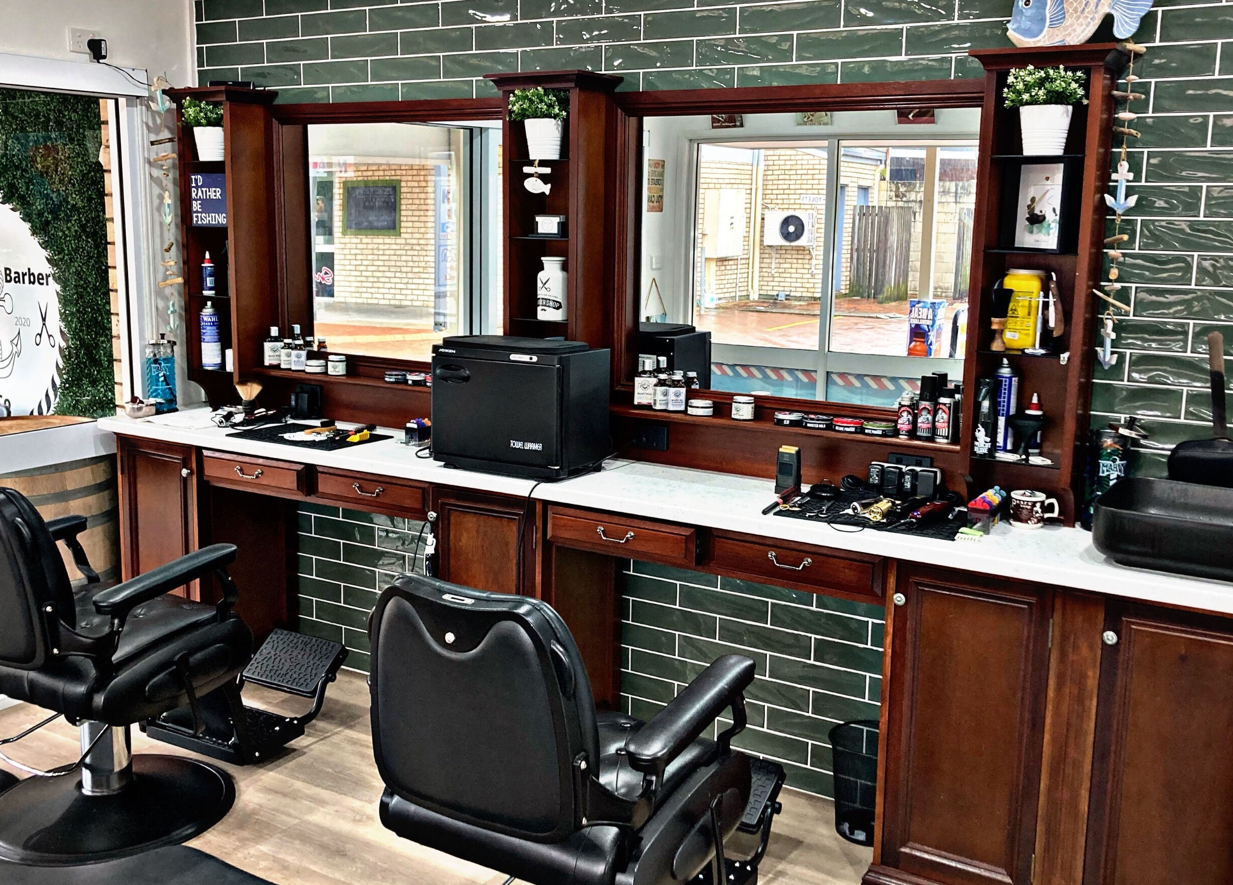 Interior of The Village Barber & Co, Scarness, Queensland, AU, showcasing elegant chairs and grooming products.