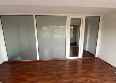 Elegant wooden flooring and sleek glass doors at French Quarter Nails in İstanbul, İstanbul, TR.