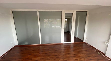 Elegant wooden flooring and sleek glass doors at French Quarter Nails in İstanbul, İstanbul, TR.