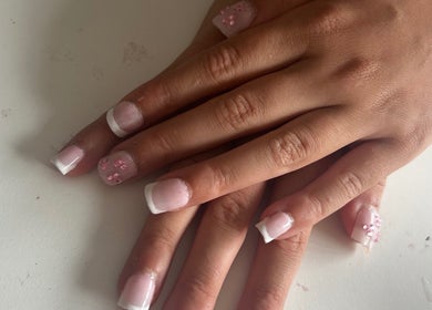 Elegant French manicure with floral designs at Gloss by Lexie, Shenstone, England, GB.
