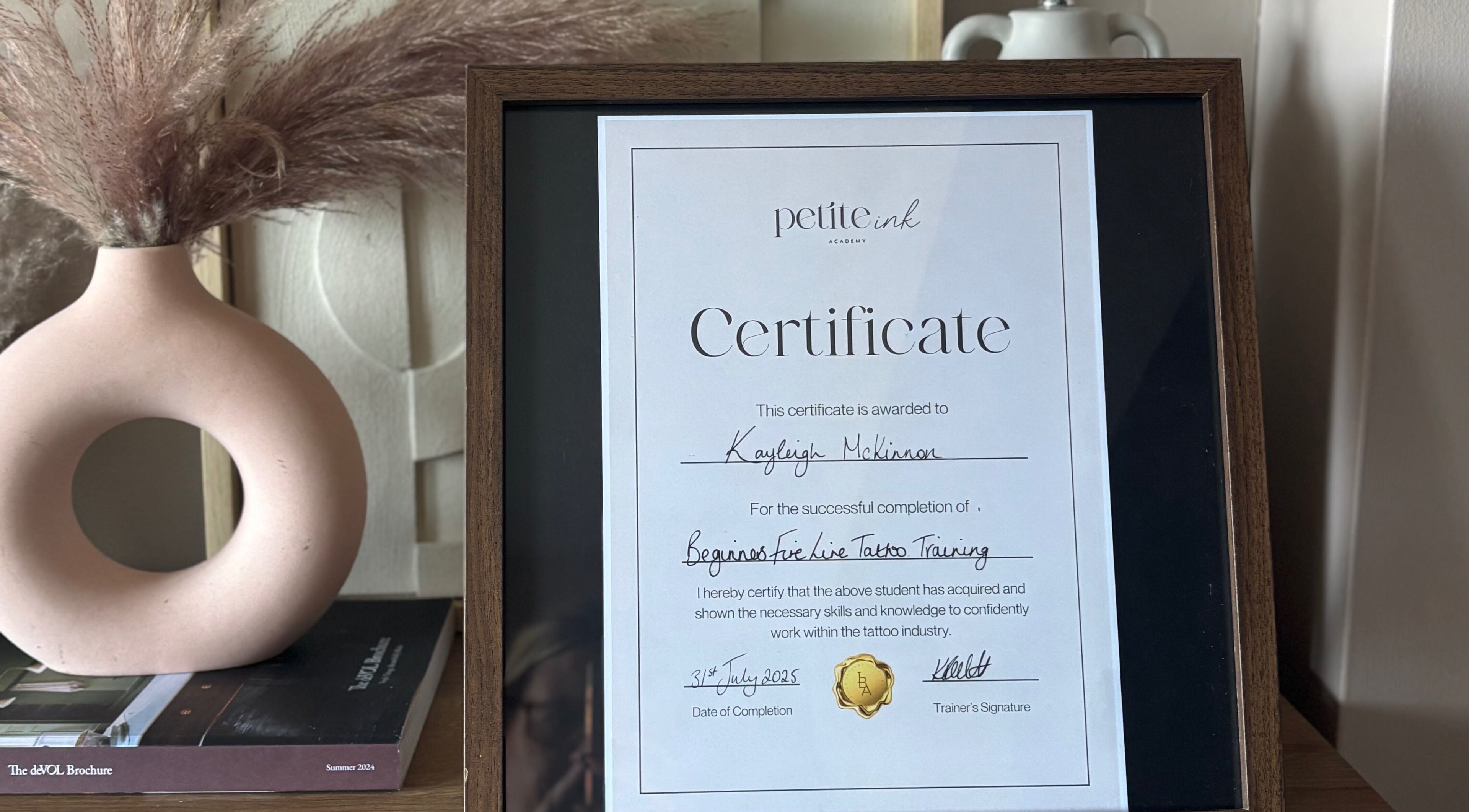 Certificate on display at Pristine Ink, Brentwood, England, GB, highlighting training completion success.