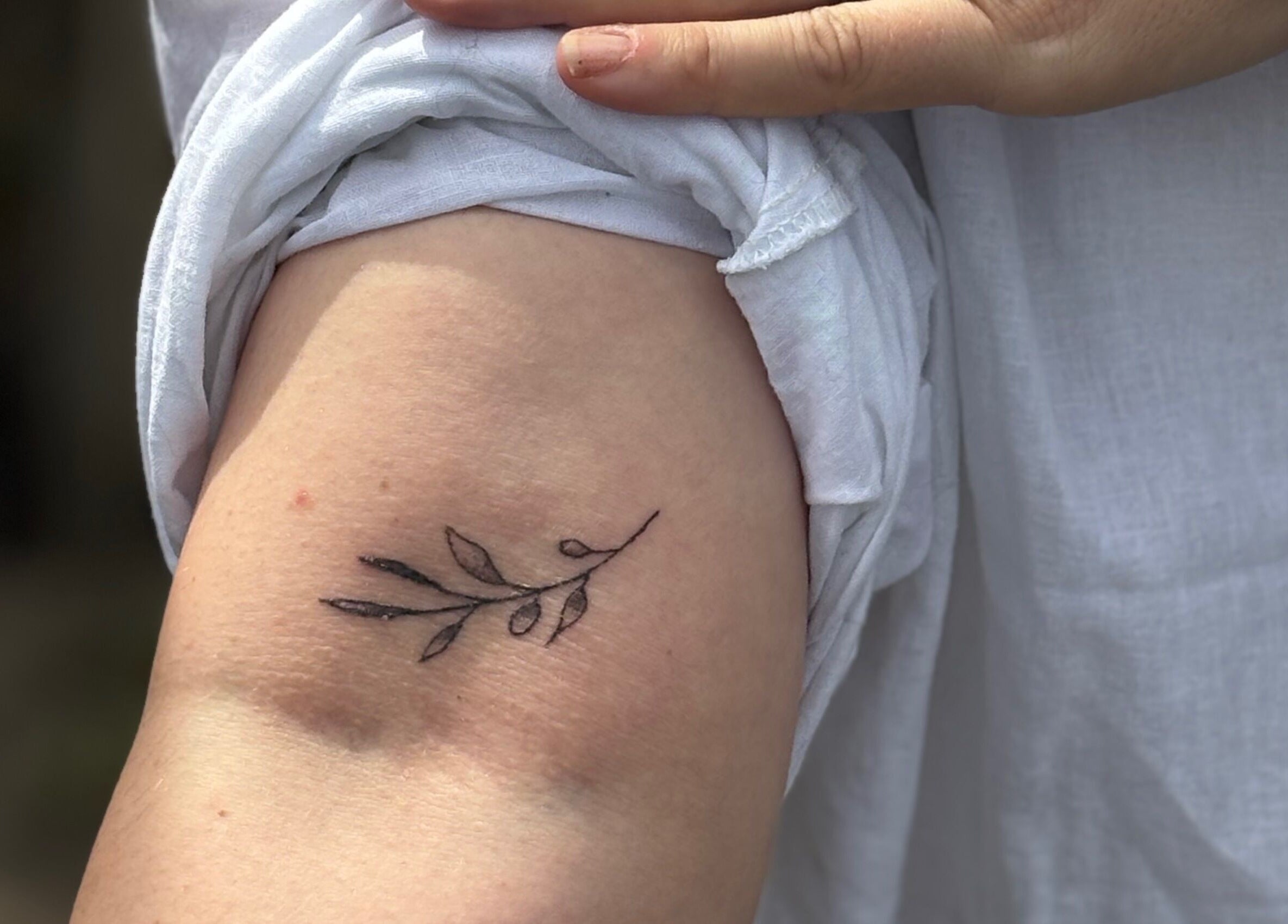 Minimalist branch tattoo at Pristine Ink, Brentwood, England, GB. Delicate and stylish body art.