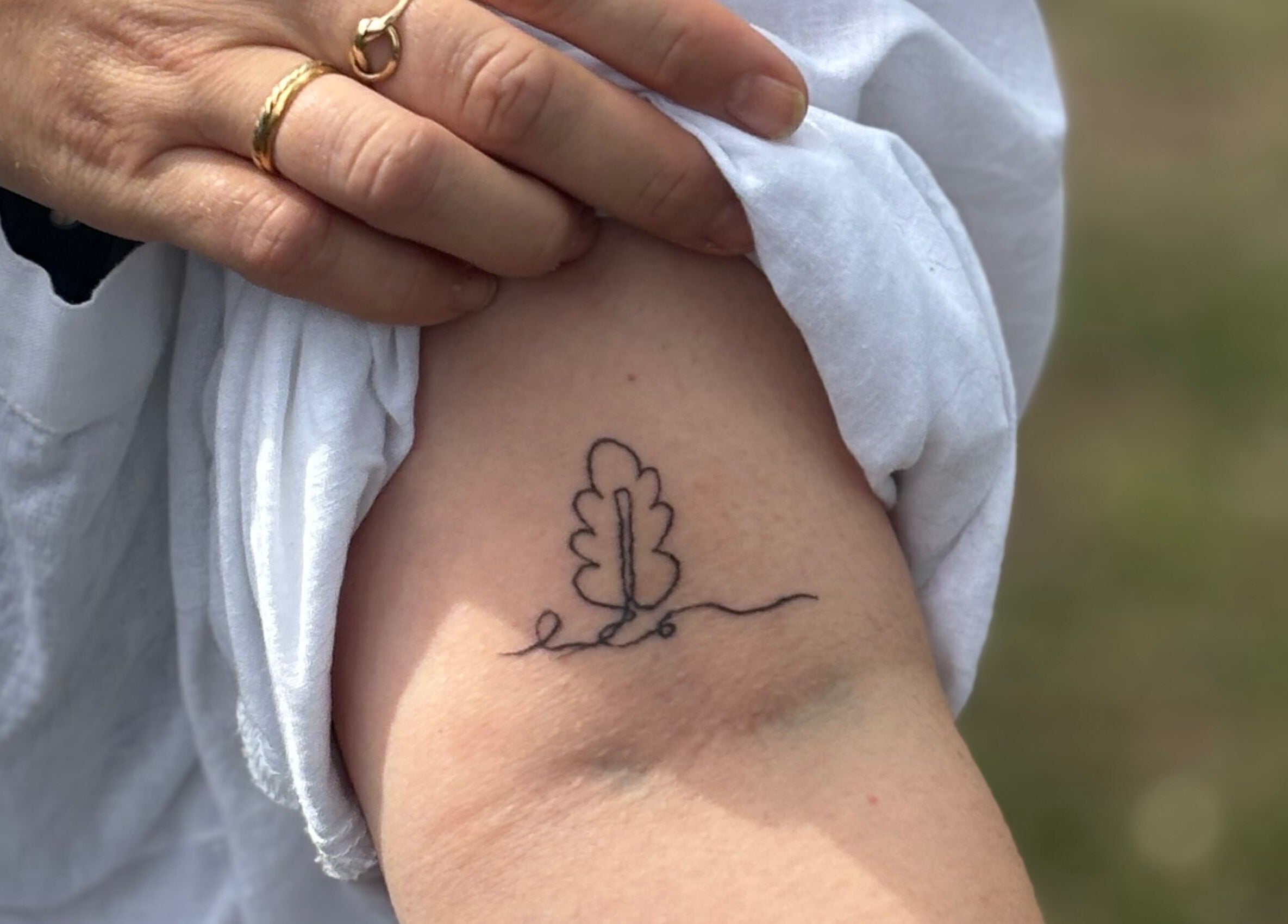 Minimalist tree line tattoo at Pristine Ink, Brentwood, England, GB. Simple elegance in body art design.