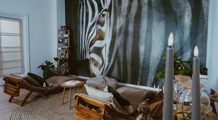 Relaxing lounge with zebra mural at INARI SPA, București, 1, RO. Cozy seating enhances the calming ambiance.
