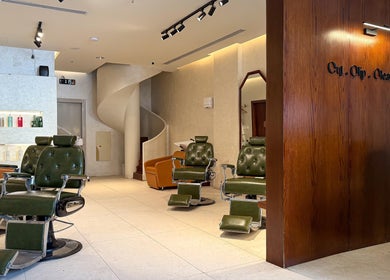 Elegant interior of Capelli Boutique barbershop, Al Khobar, Eastern Province, SA, featuring plush chairs and a stylish atmosphere.