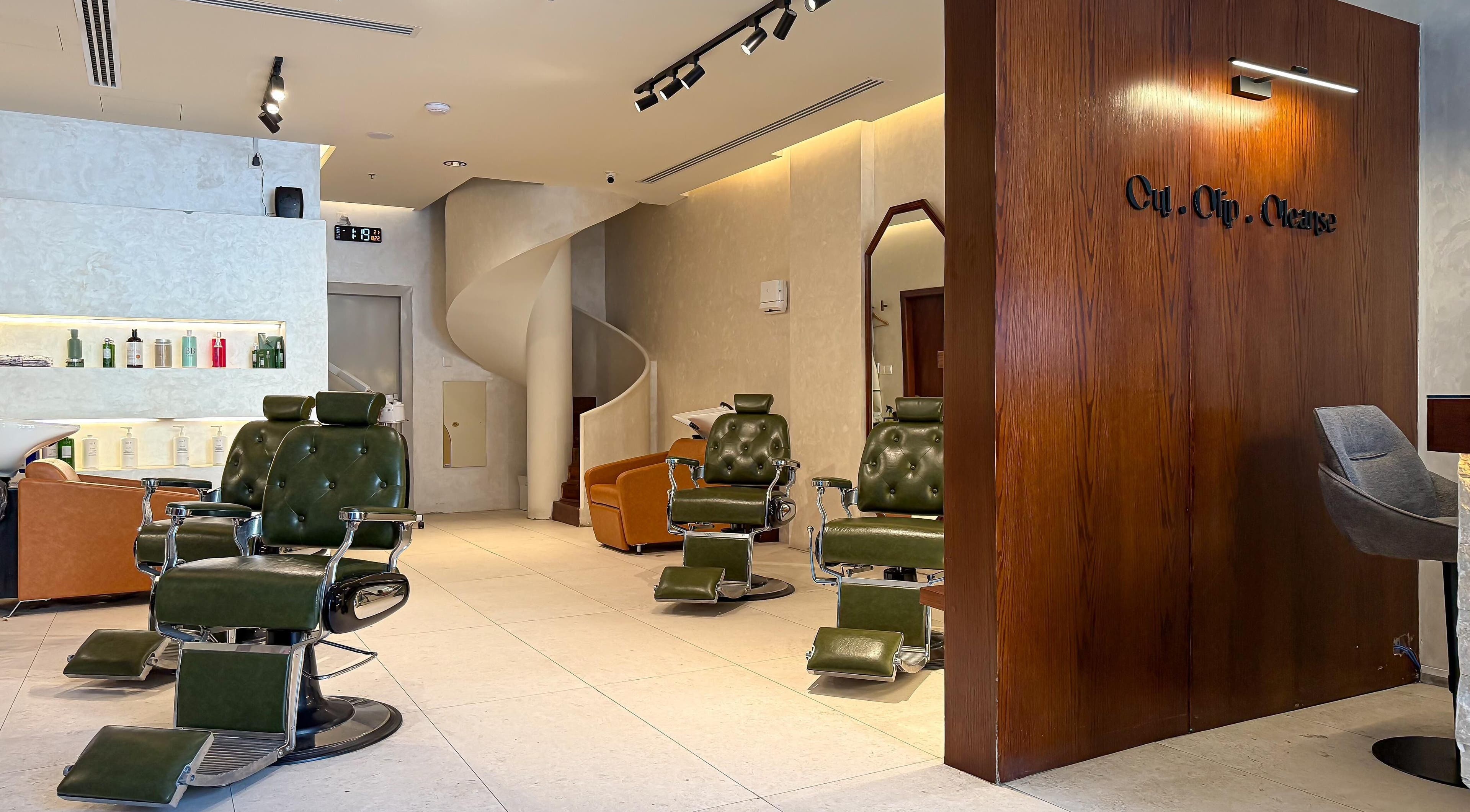 Elegant interior of Capelli Boutique barbershop, Al Khobar, Eastern Province, SA, featuring plush chairs and a stylish atmosphere.