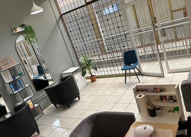 Interior of Sha Ree Shi Beauty Studio, Johannesburg, Gauteng, ZA, showcasing modern seating and ample lighting.