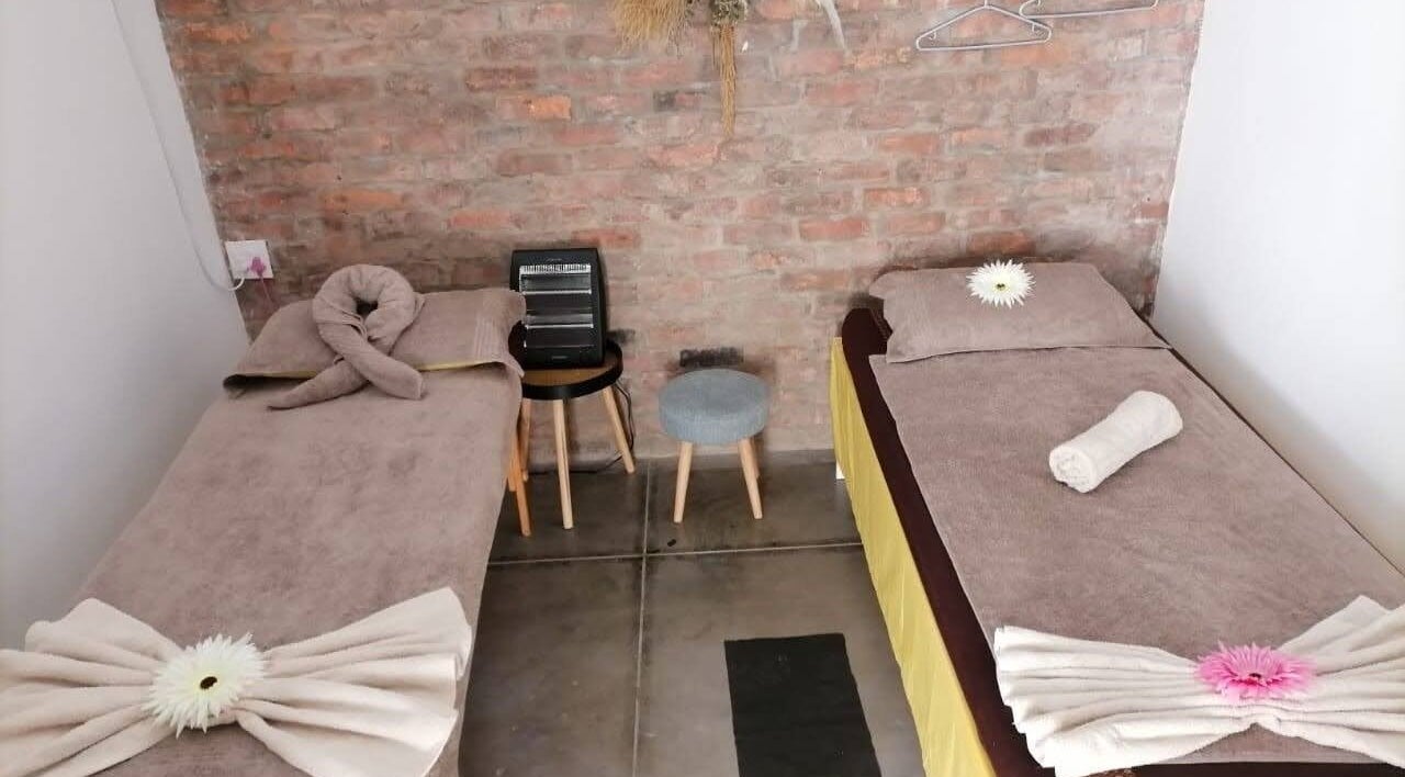 Cozy massage beds at Ubuhle Health and Wellness Spa, Jeffreys Bay, Eastern Cape, ZA with serene decor.