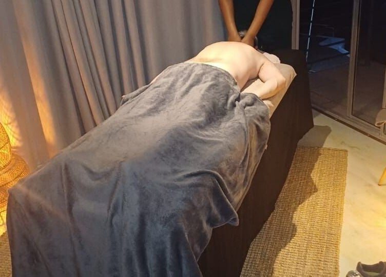 Relaxing massage service at Ubuhle Health and Wellness Spa, Jeffreys Bay, Eastern Cape, ZA, with ambient lighting.