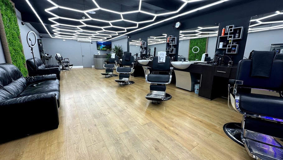 Modern interior of Hair & Comb salon in London, England, GB with stylish chairs and elegant lighting.