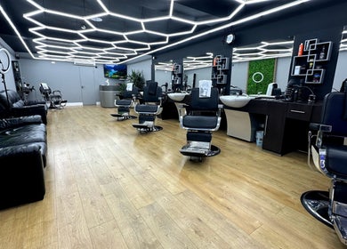 Modern interior of Hair & Comb salon in London, England, GB with stylish chairs and elegant lighting.