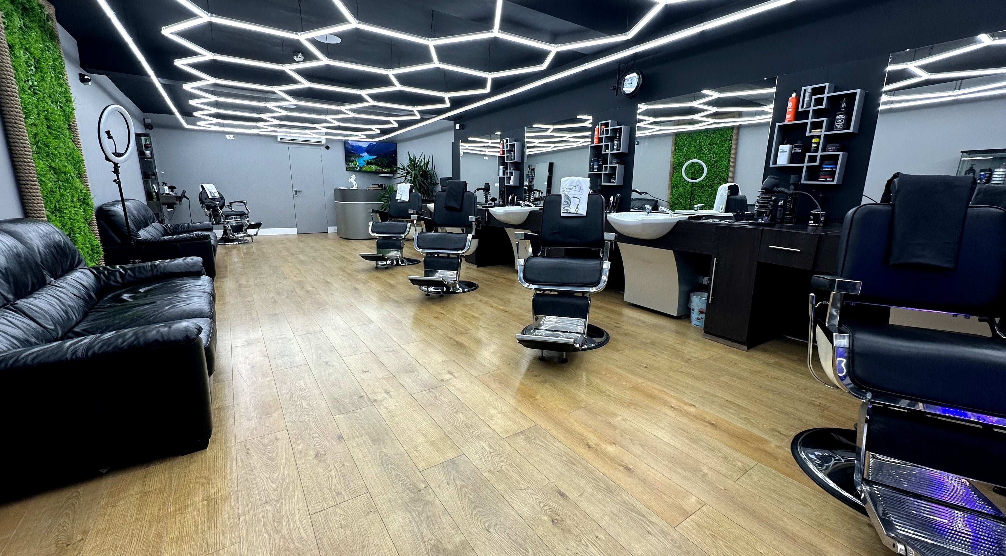 Modern interior of Hair & Comb salon in London, England, GB with stylish chairs and elegant lighting.