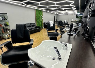 Modern salon interior at Hair & Comb in London, England, GB with stylish chairs and elegant decor.