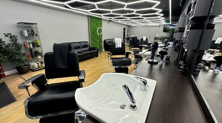 Modern salon interior at Hair & Comb in London, England, GB with stylish chairs and elegant decor.