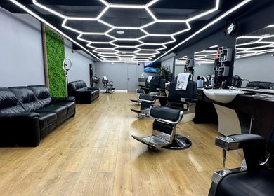 Elegant interior of Hair & Comb salon, London, England, GB, with sleek black chairs and stylish lighting.