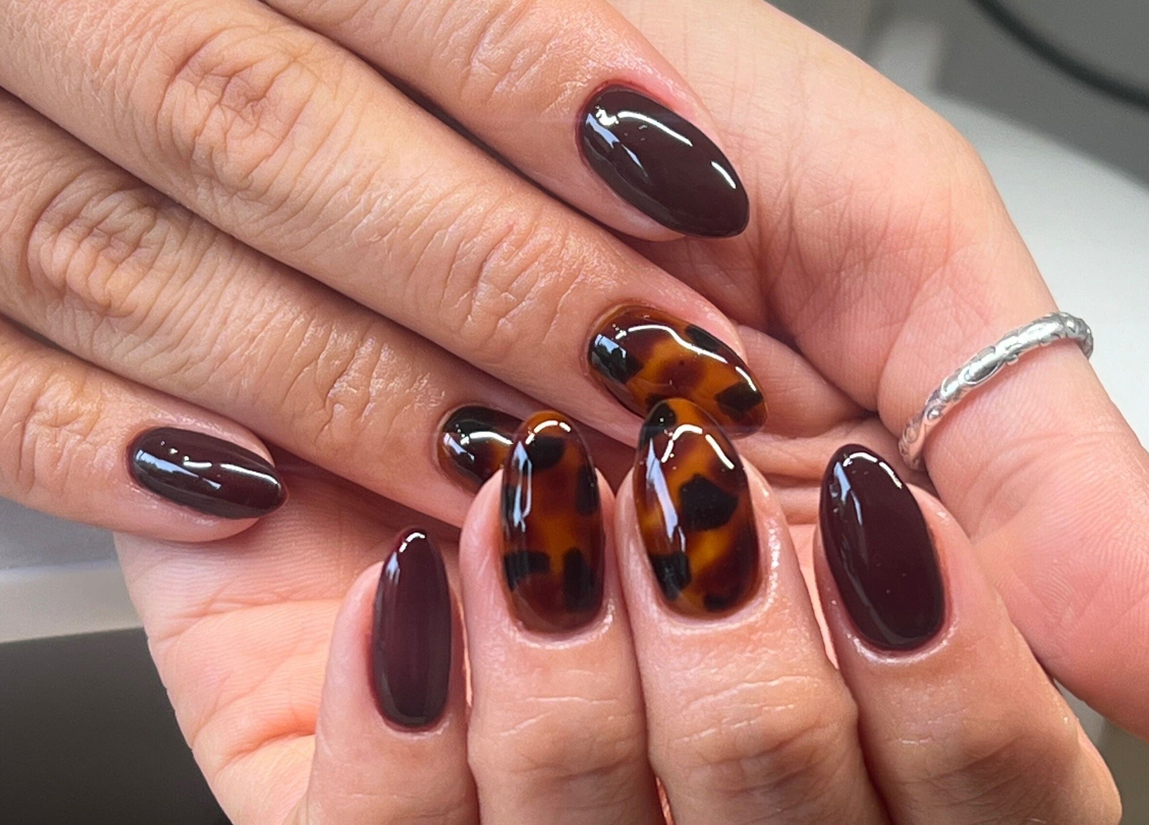 Tortoiseshell nail art at Serene Mani’s in Stevenage, England, GB, showcasing stylish and polished hands.